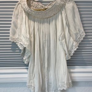 Off the should blouse with crocheted detail on sleeve and shoulder.